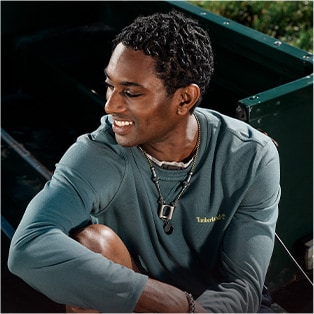 closeup image of a man wearing a blue Timberland long sleeve shirt